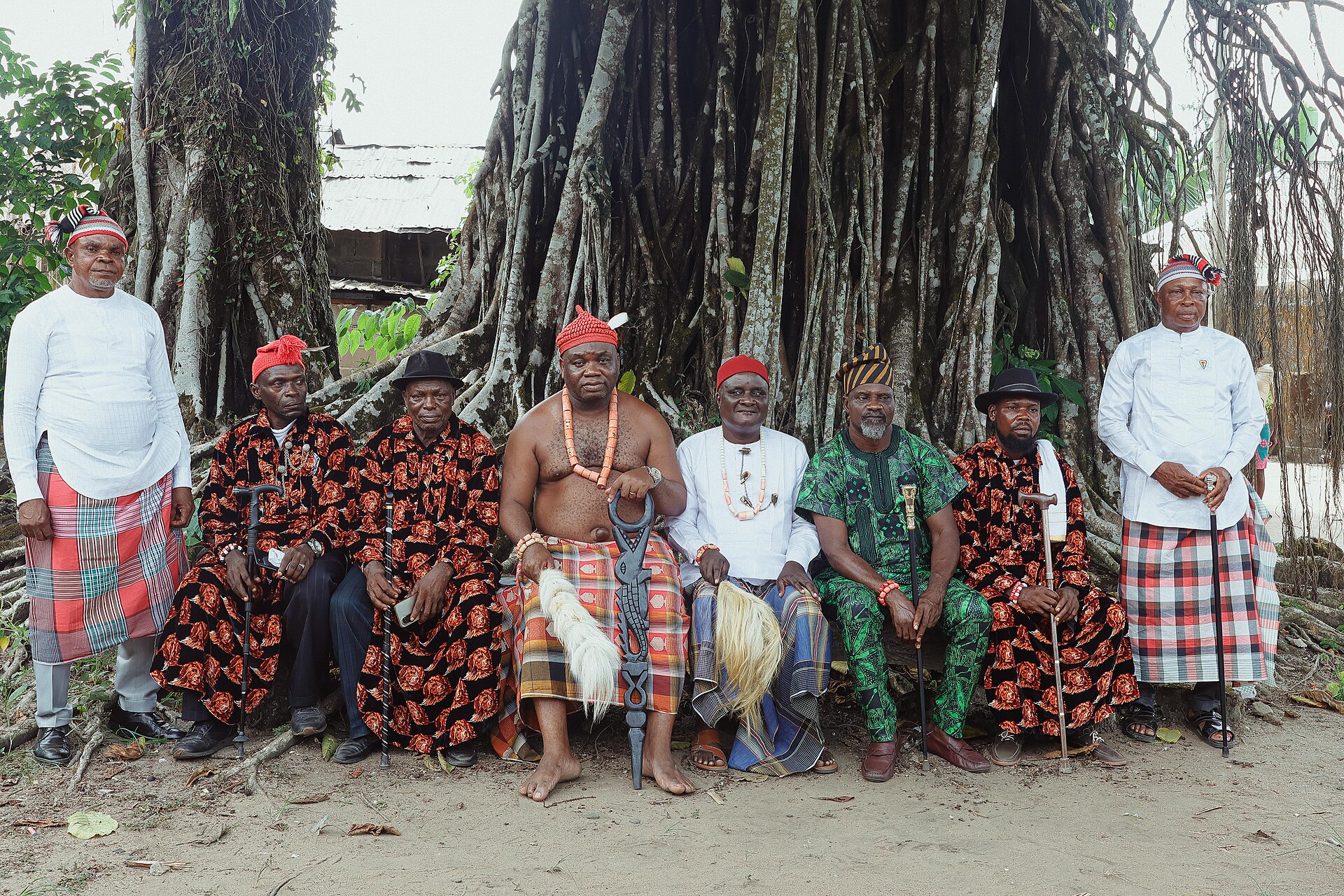 A group of Nigerian men in traditional attire pose for a portrait, representing keepers of local knowledge.